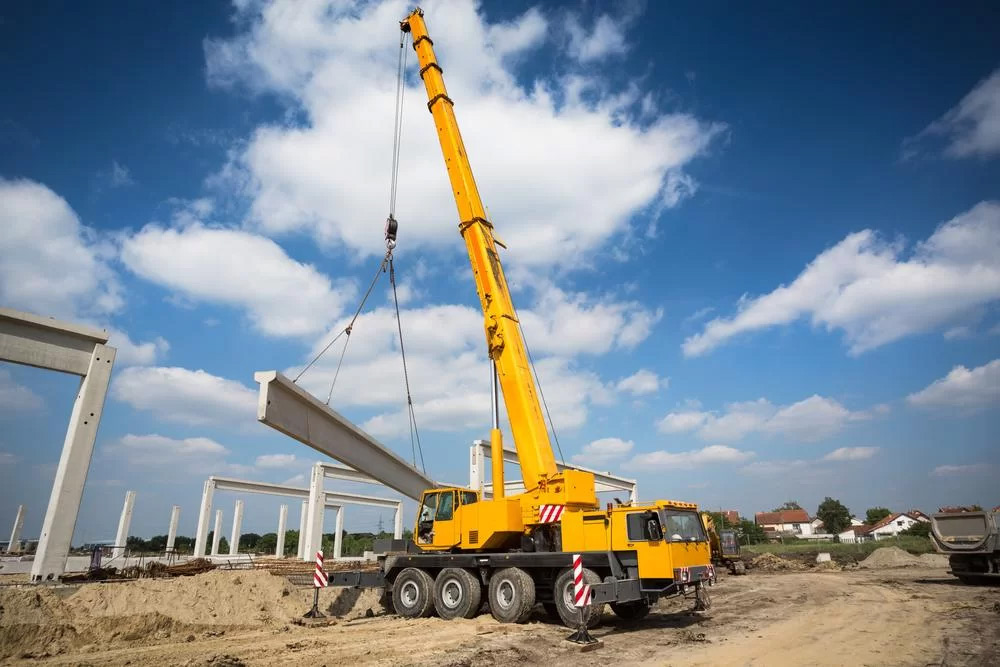 Crane lifting a structural element on a project site